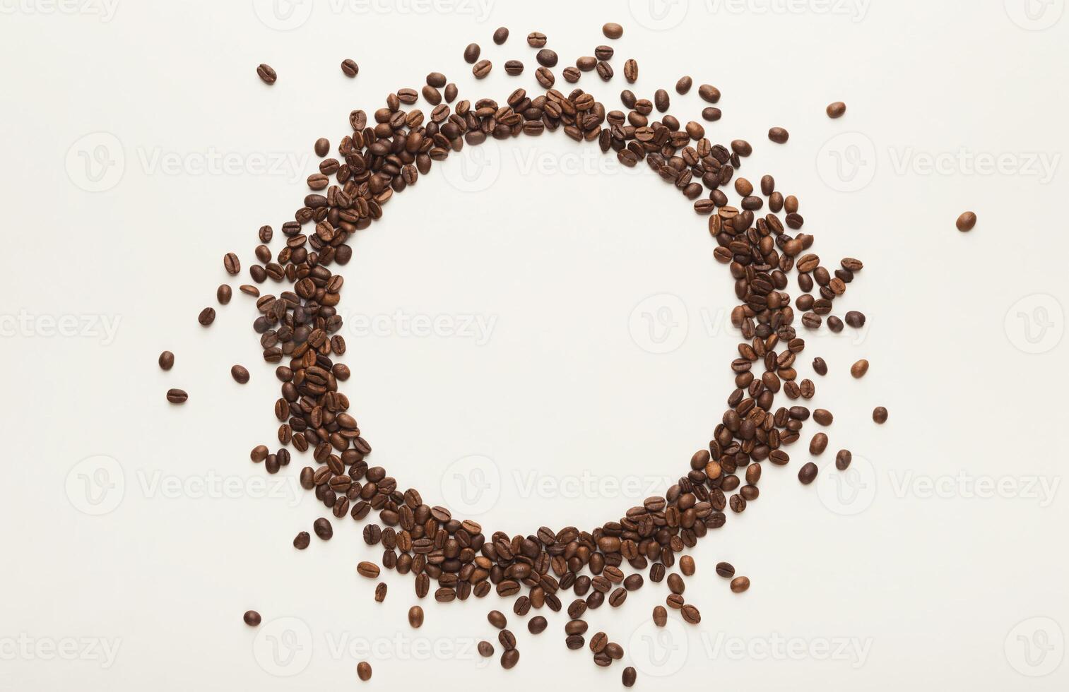 Empty circle drawn with coffee beans on white isolated background. Mockup for advertizing, copy space for text, top view photo