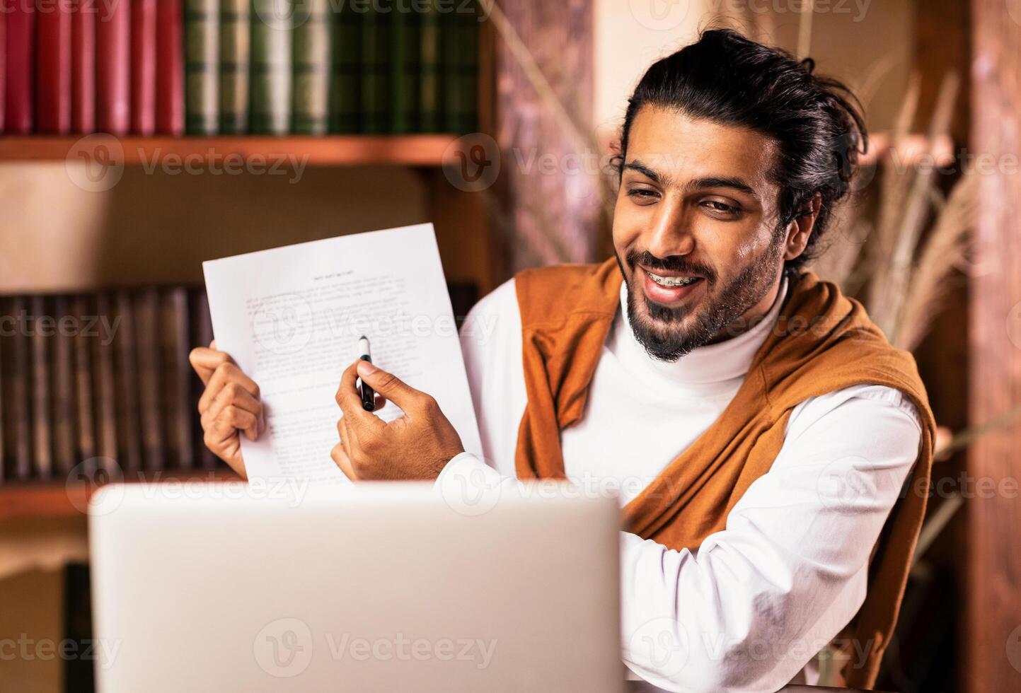 Remote Teaching And e-Learning. Indian Teacher At Laptop Having Online Class With Distant Student Sitting Indoors. Modern Tutoring, College And School Education Distantly, E-Teaching. Selective Focus photo