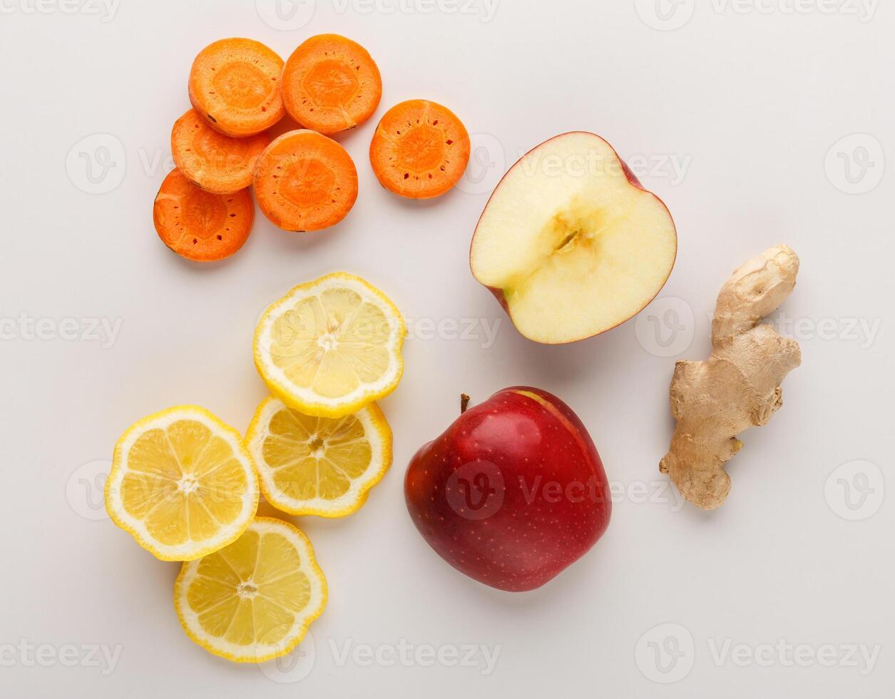 Healthy food. Ingredients for detox smoothie, ginger, carrot, apple, lemon on white background, top view, copy space. photo
