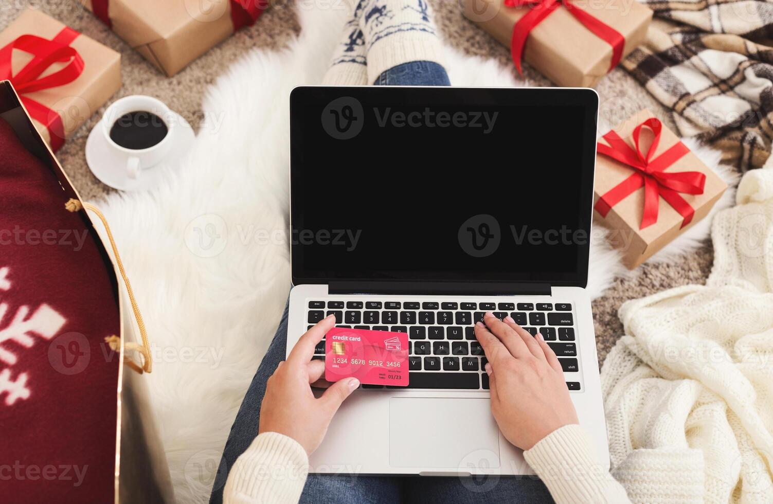 Christmas online shopping. Woman buying presents for xmas on laptop with credit card, copy space on screen photo