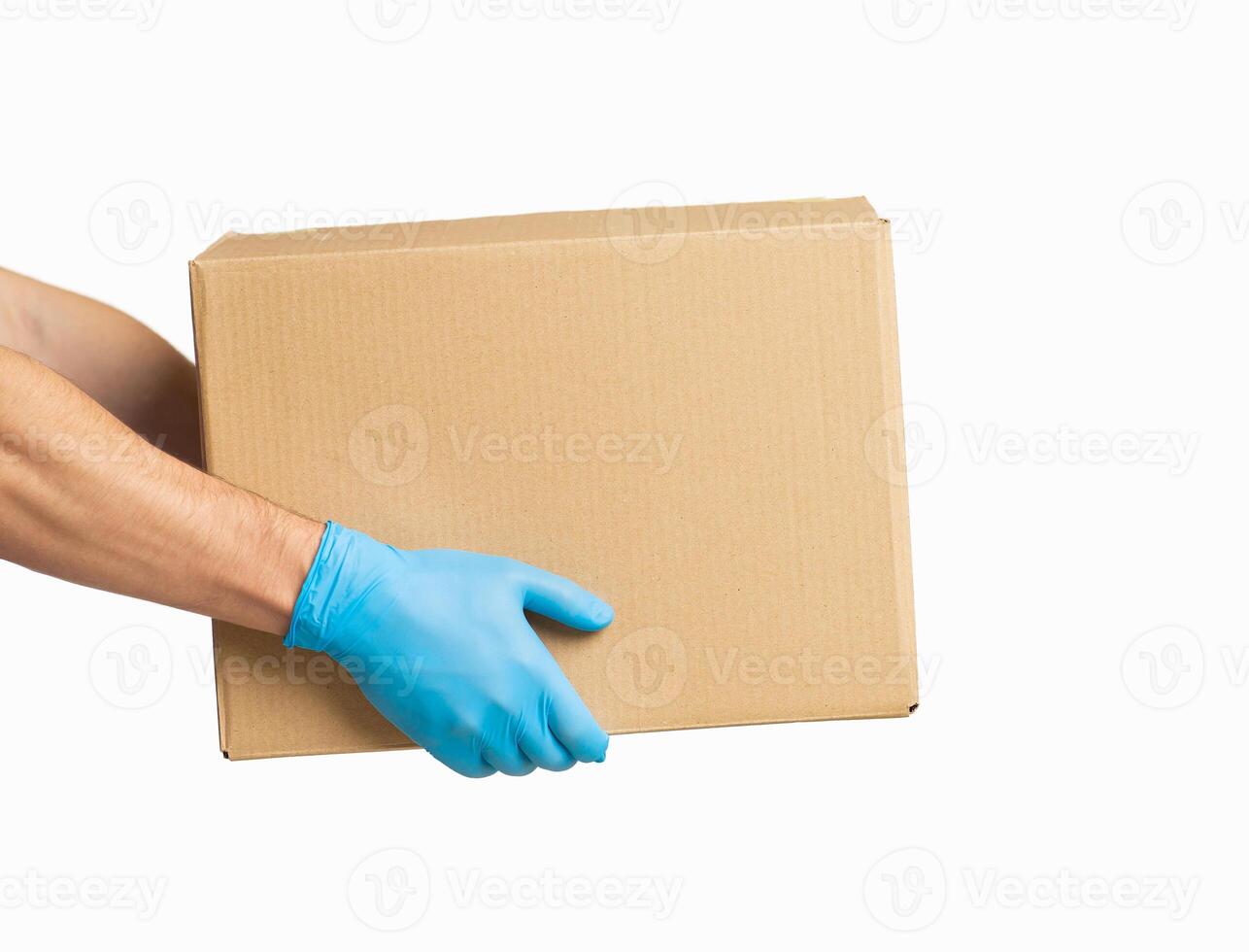 Courier presents cardboard box in rubber gloves, side view photo