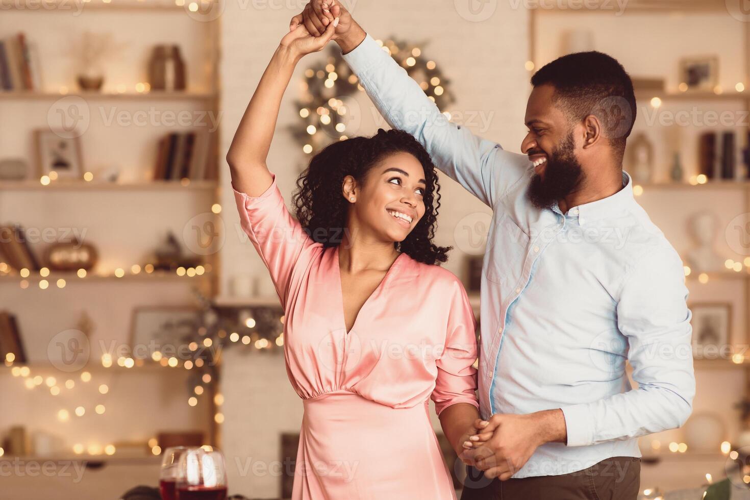 Happy Loving Family. Portrait of beautiful young african american couple in love dancing and looking at each other. Smiling black bearded man having fun with his pretty excited woman photo