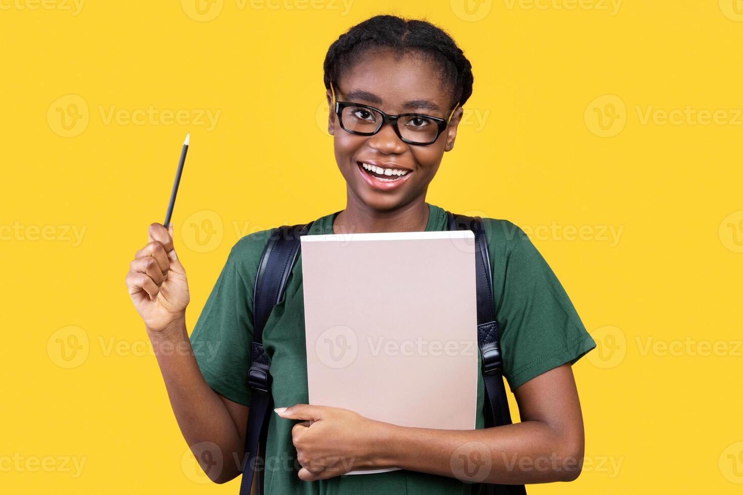 I Have Idea. Happy Creative African Student Woman Holding Pencil Having Inspiration Standing With Books And Copybooks On Yellow Studio Background, Smiling To Camera. Eureka Moment photo