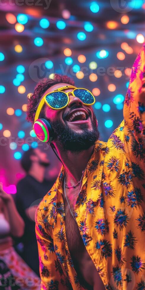 A man wearing sunglasses and a colorful shirt dancing at a party photo