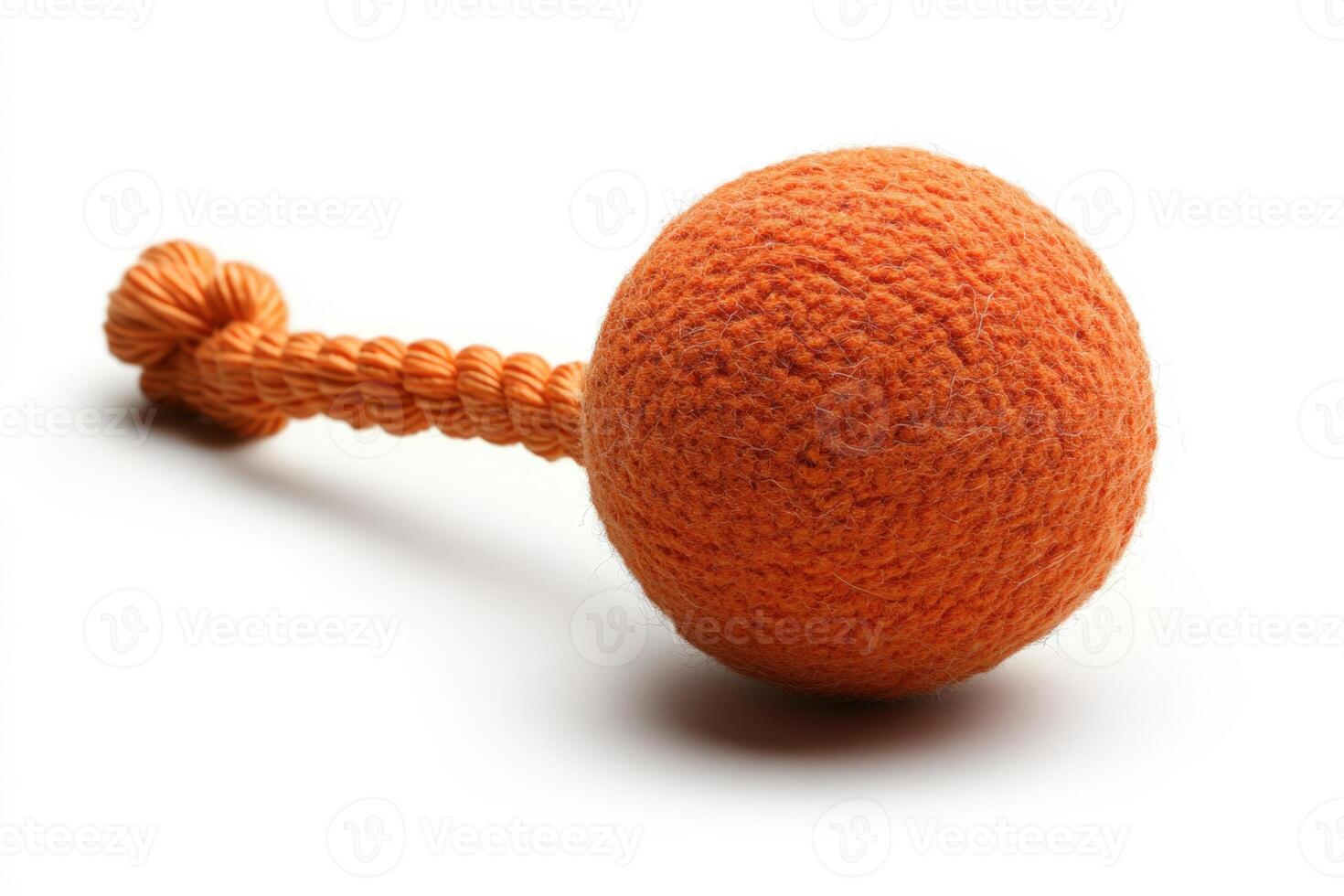 A knitted orange ball on a white background photo