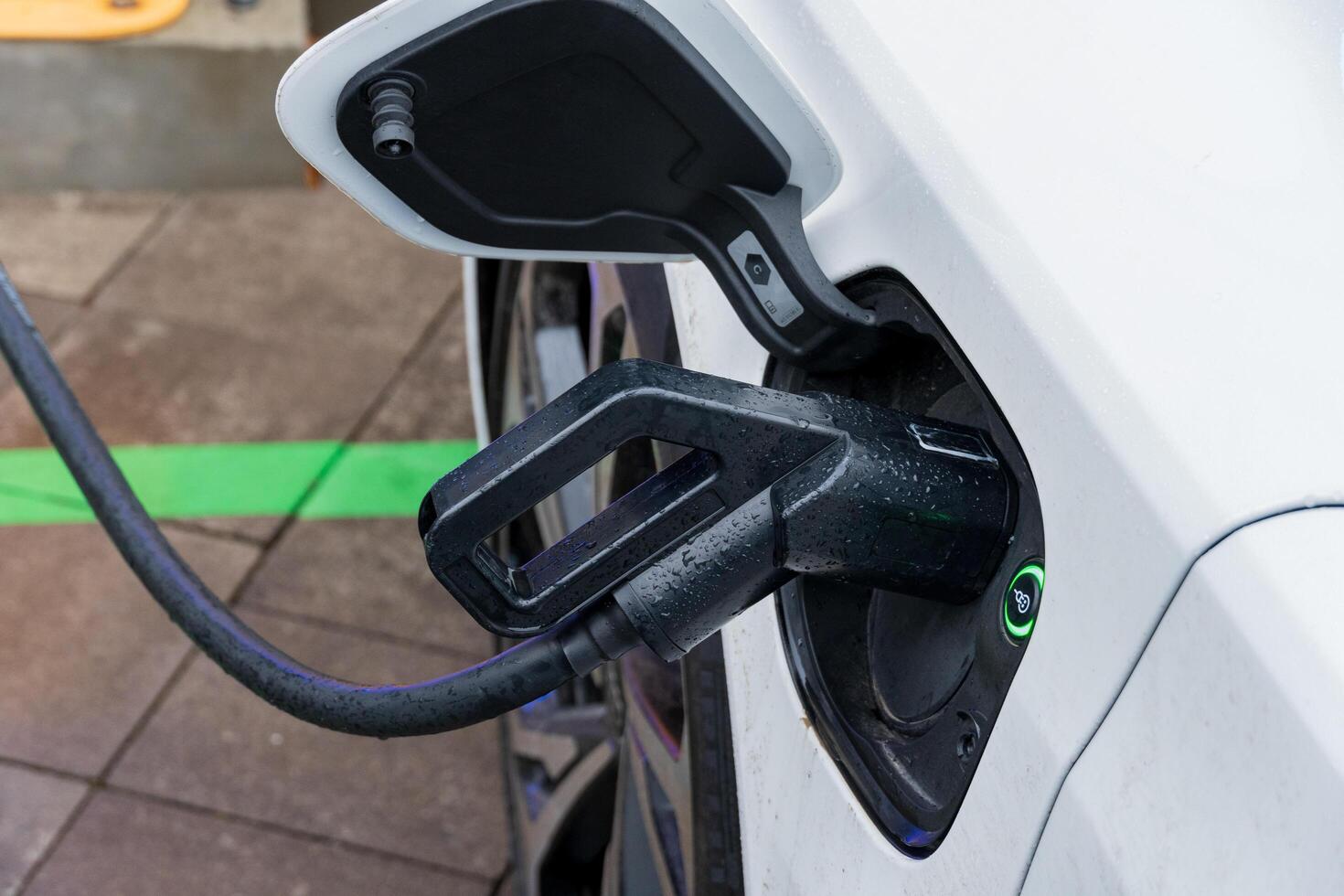 An electric vehicle connects to a sleek charging station, showcasing advanced technology for energy efficiency and eco-friendly transportation options photo