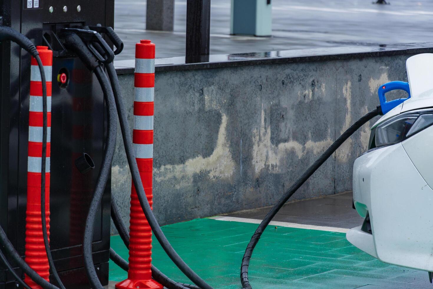 A sleek electric vehicle connects to a charging station, highlighting the modern advancement in energy solutions photo