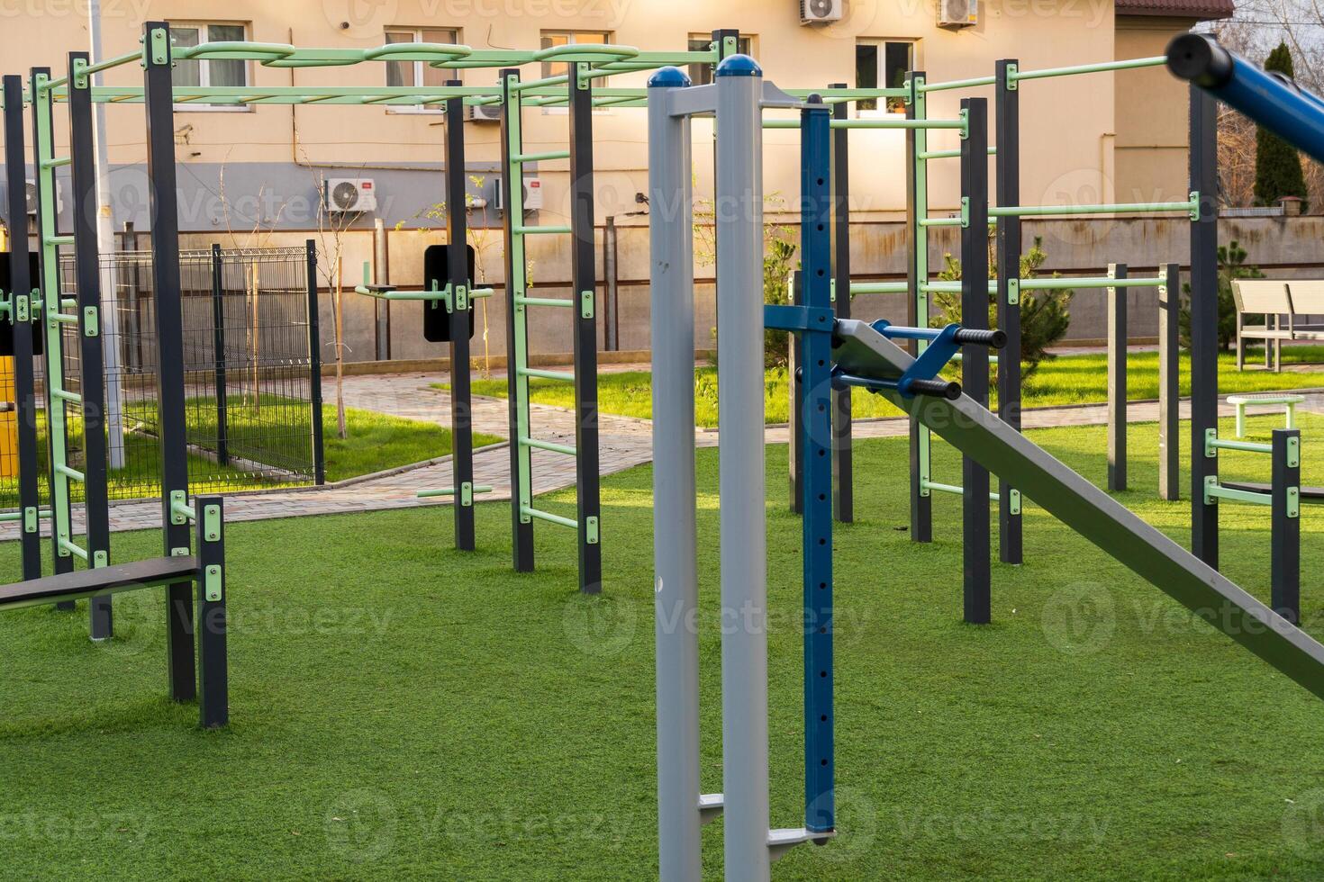 This dynamic fitness space features various gym equipment and exercise machines, perfect for both individual workouts and group training sessions. The green environment encourages a healthy lifestyle photo