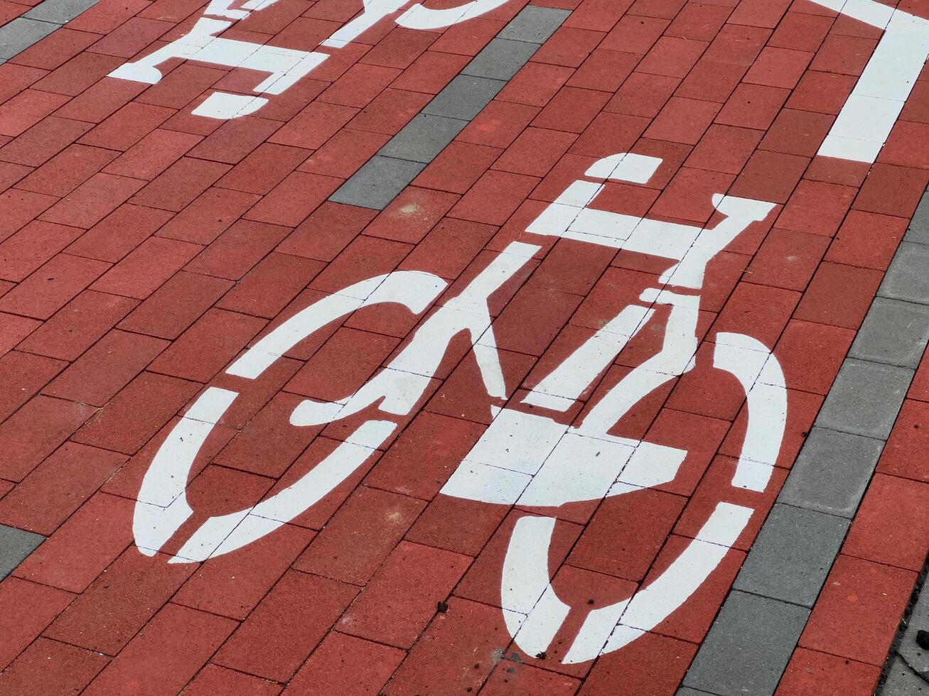 A clearly defined bicycle lane is visible with white markings on red paving, promoting cycling and ensuring safety for cyclists in the city photo