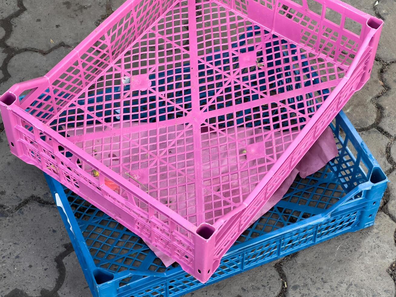 Brightly colored crates are stacked, showcasing a lively market filled with various products. The atmosphere is vibrant and busy, reflecting a bustling trade environment photo