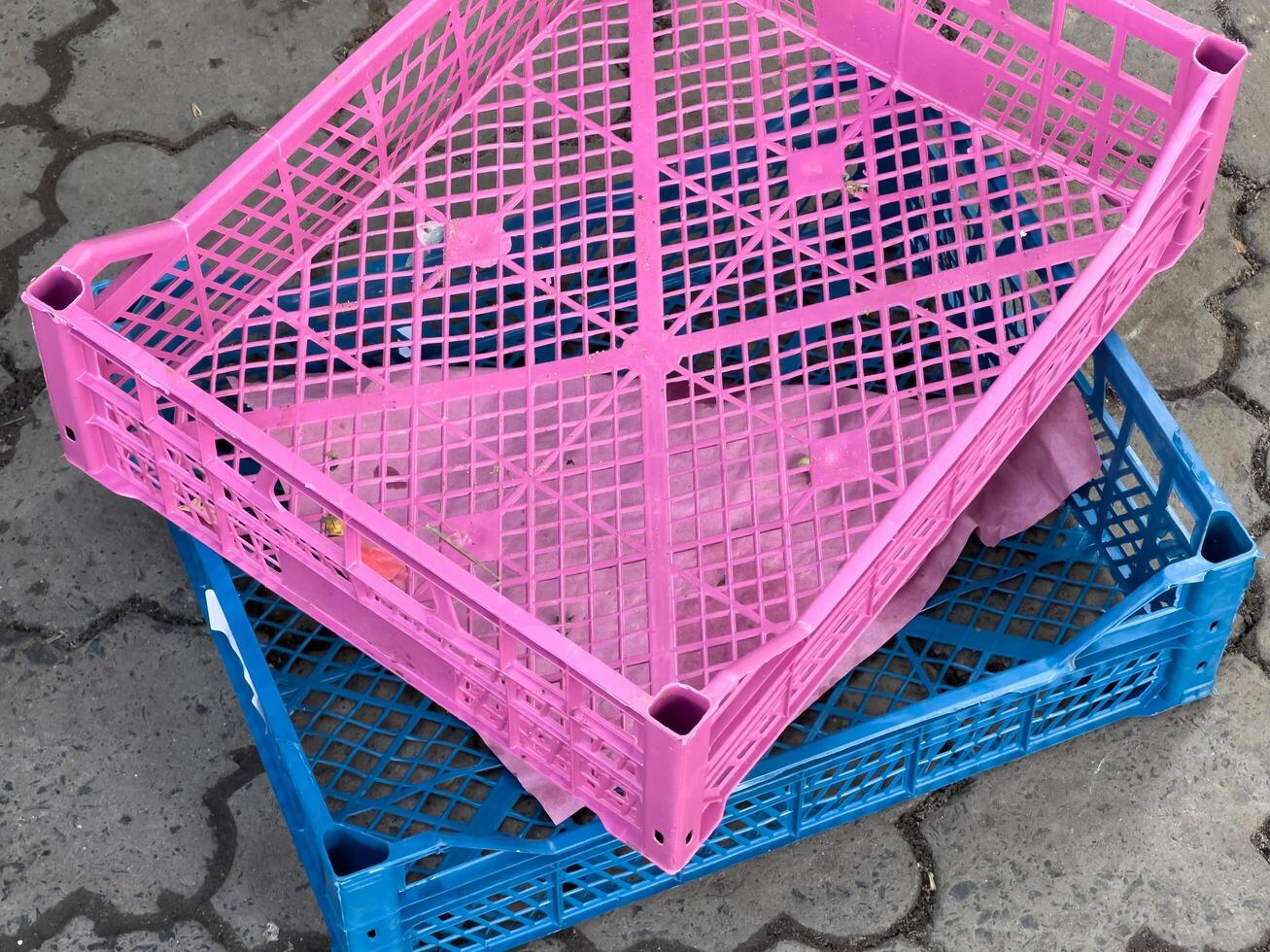 Brightly colored crates are stacked together in a lively market filled with activity, ready to display various goods for eager customers photo