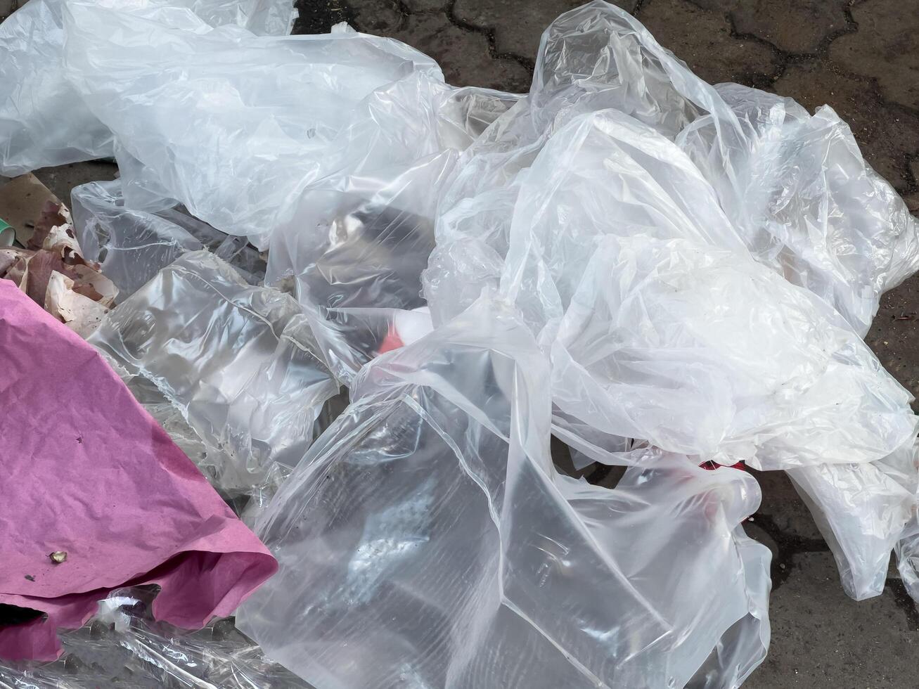 Various pieces of discarded plastic and debris lay across the pavement, reflecting the pressing issues of pollution and urban waste management in city life photo