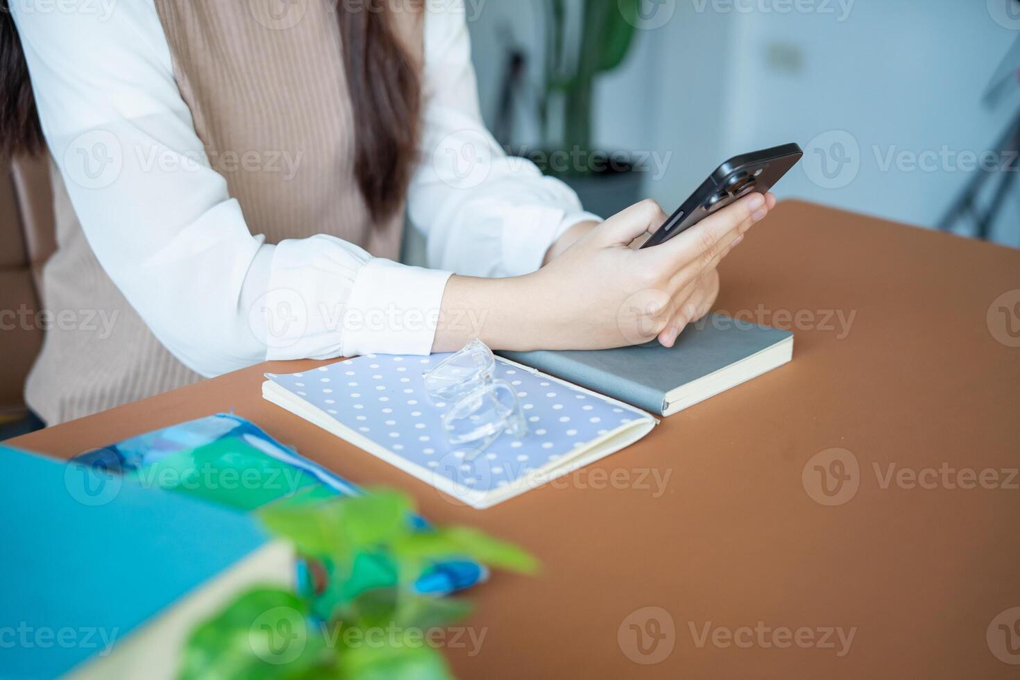 Student asian woman lying use smart phone in dorm room college mobile addict spending time checking news. photo