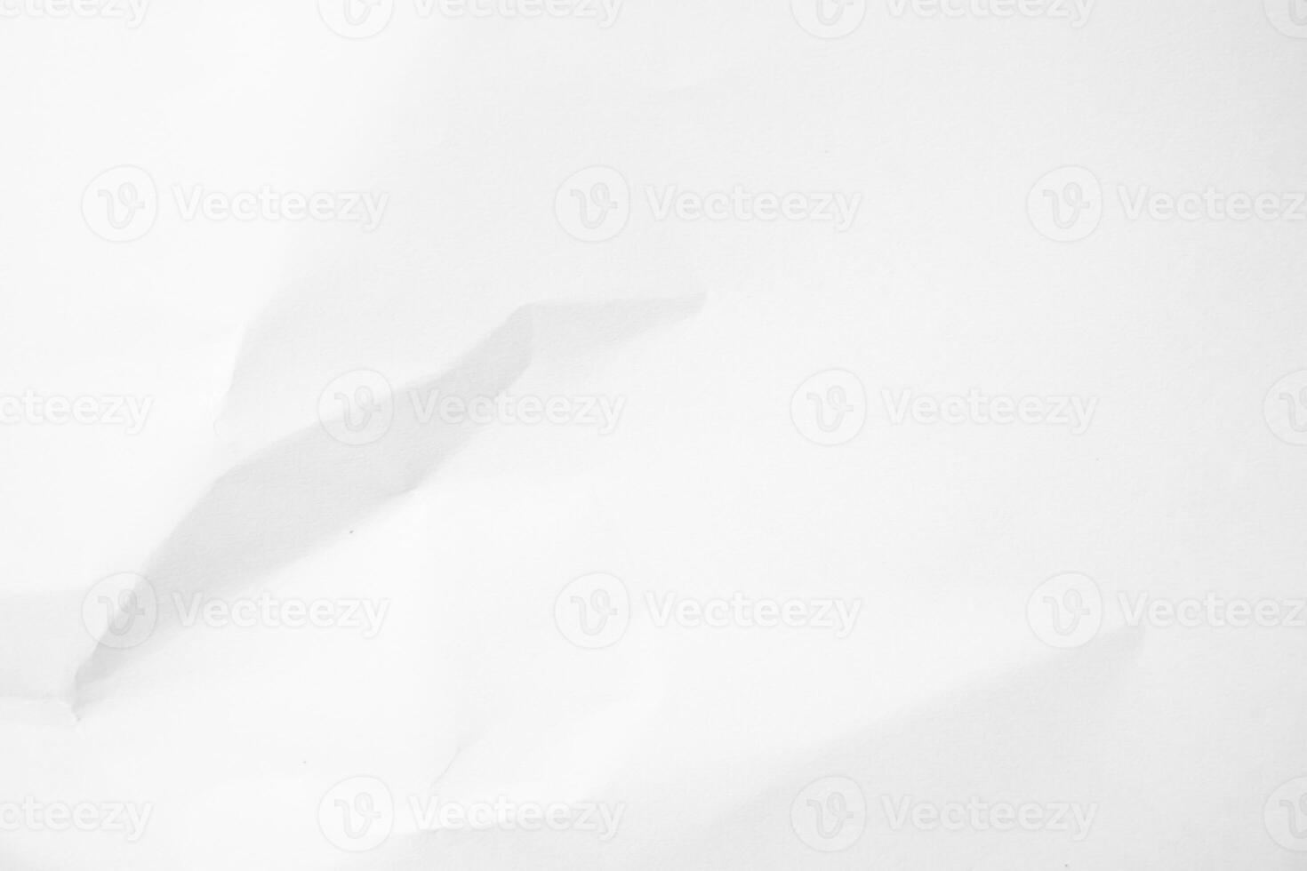 white paper crumpled on a white surface photo