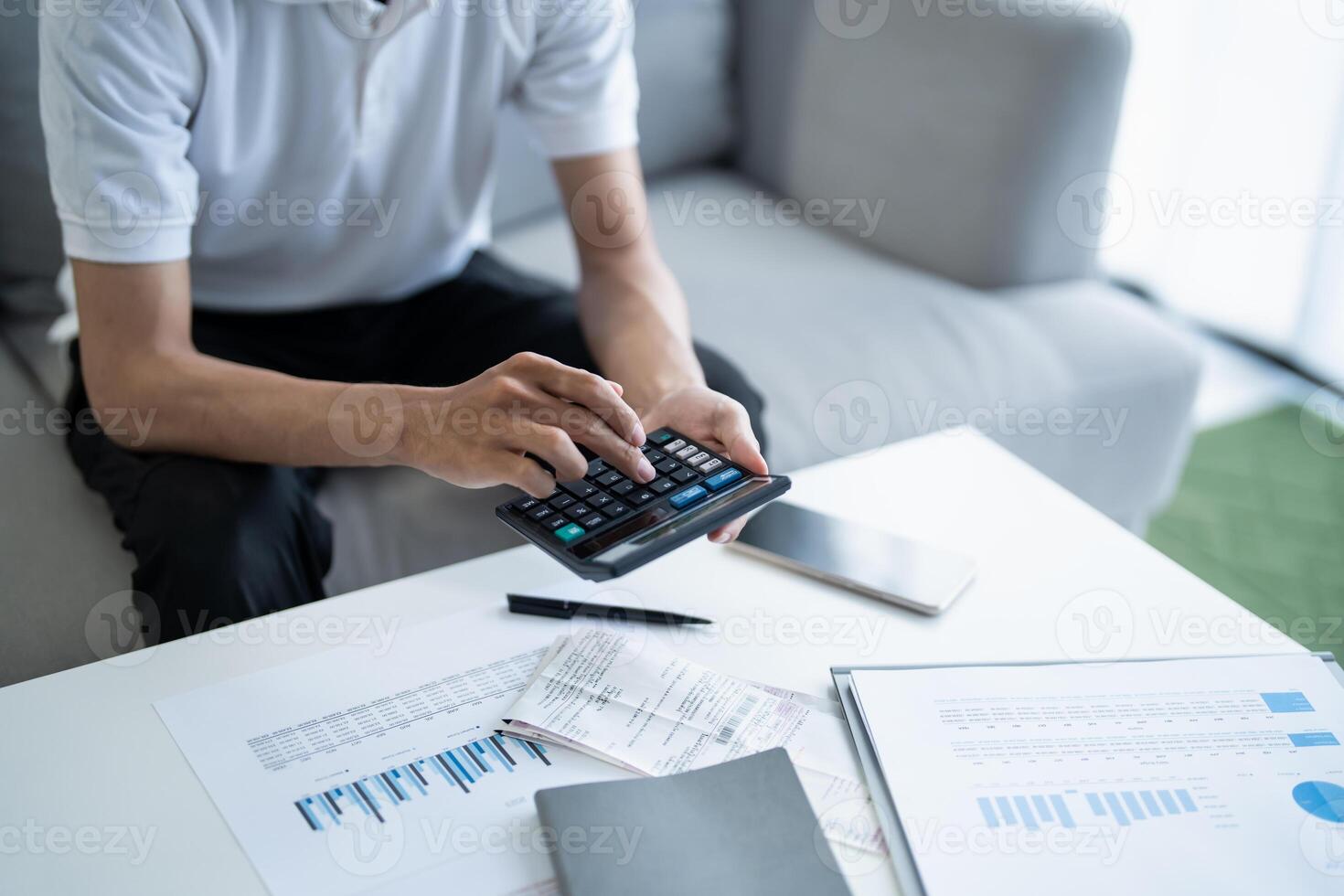 a man is using a calculator financal on a table photo