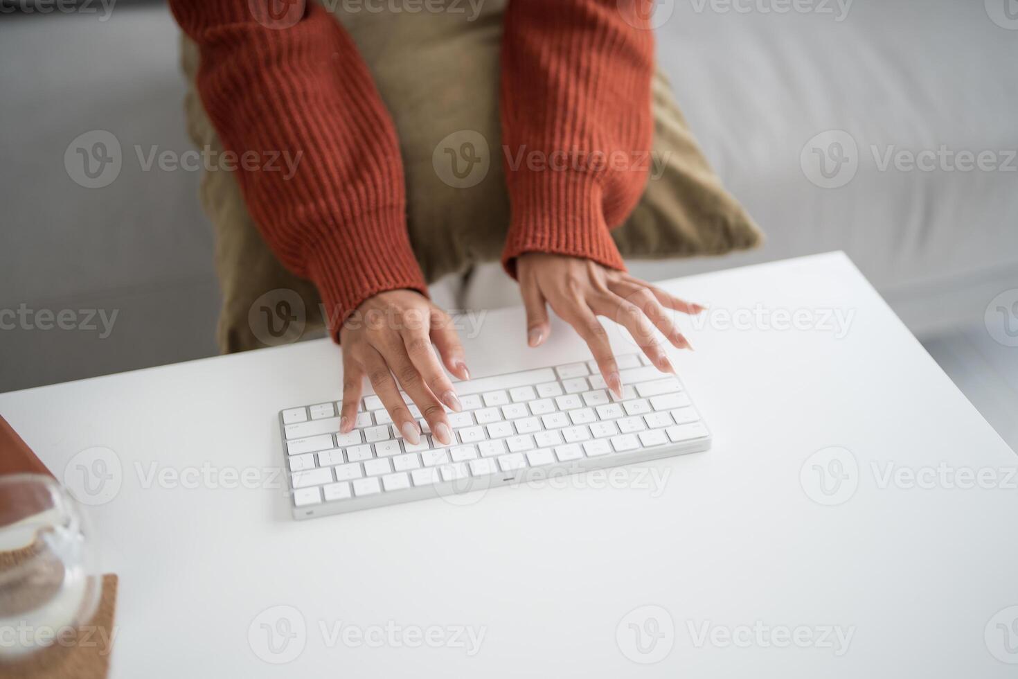a woman is typing on a keyboard photo