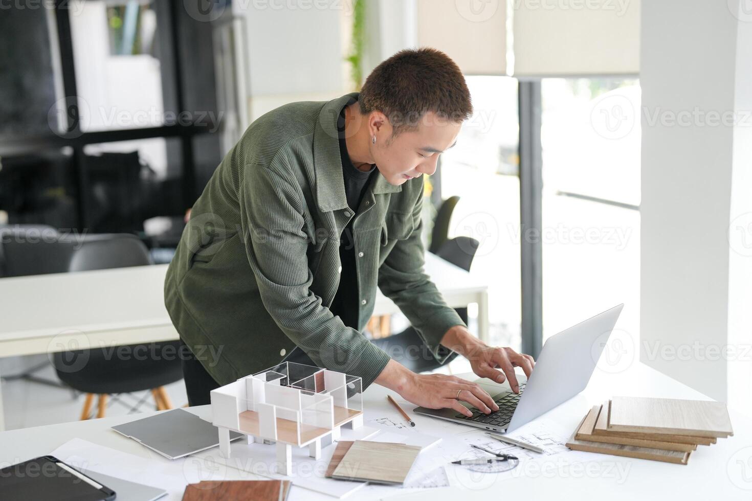 Architecture is working on his laptop in an office photo