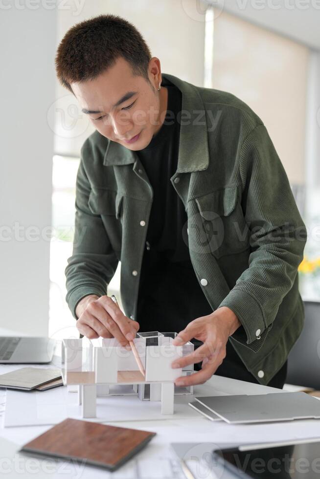 interior designer is working on a model of a house photo