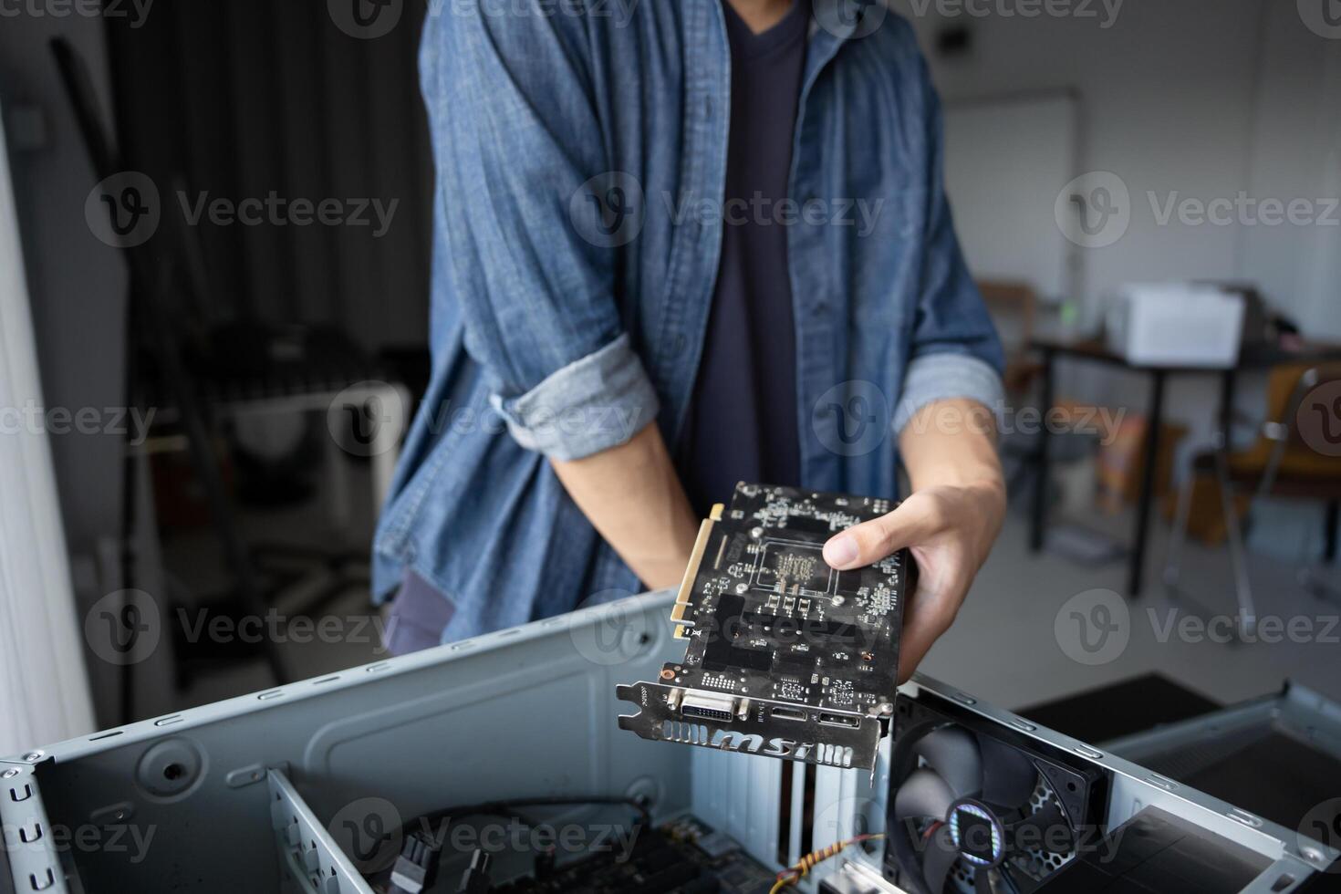 IT Engineer holding a computer motherboard in his hands photo