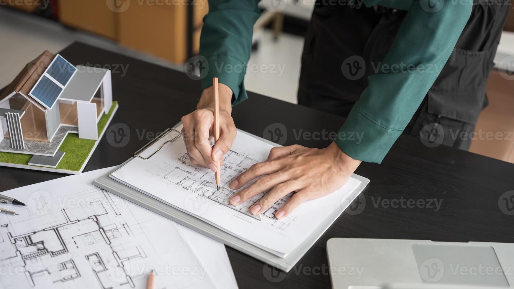 architectural design concept, architect drawing on paper with model house photo