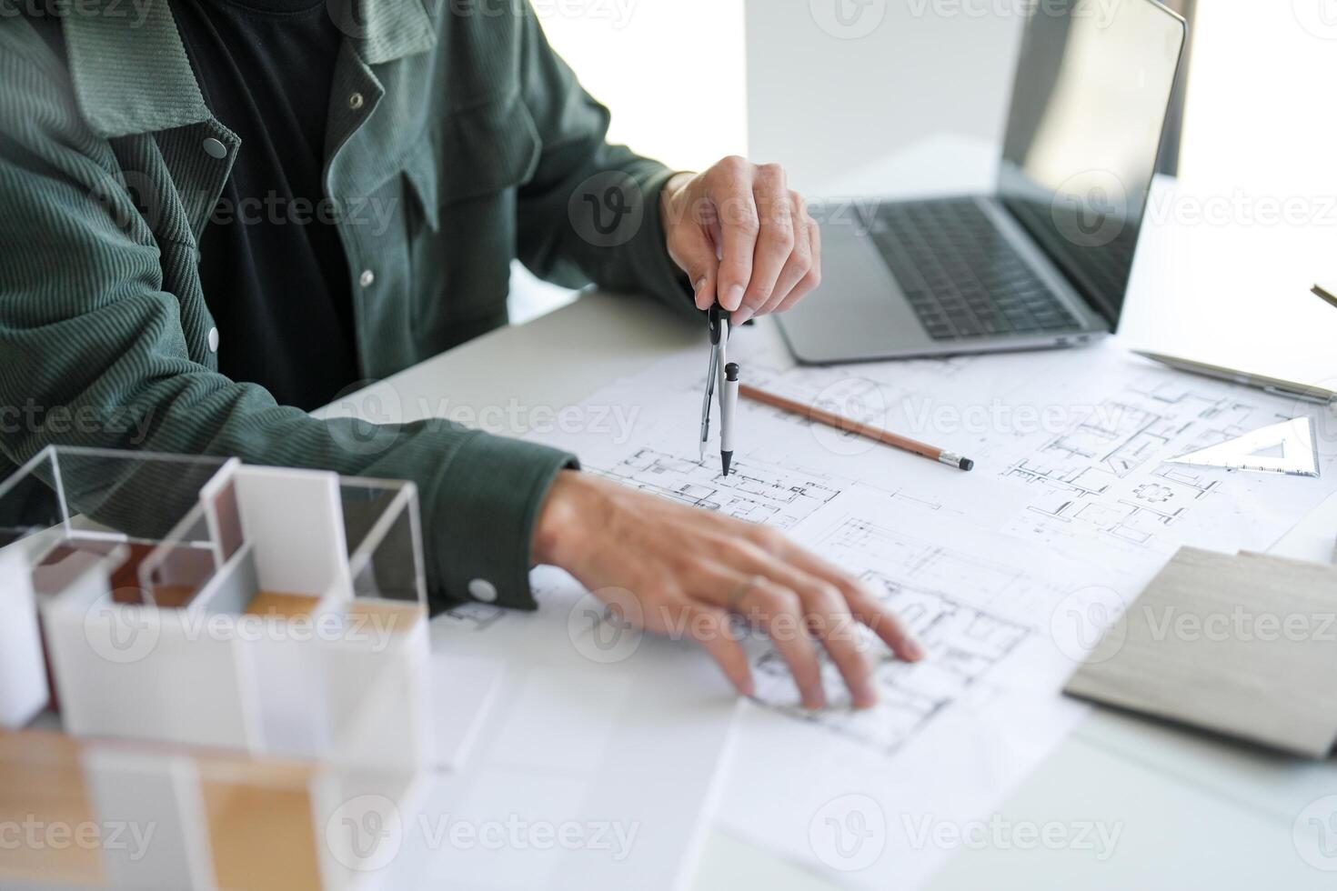 Architecture interior man is working on a project with a laptop and a pencil photo