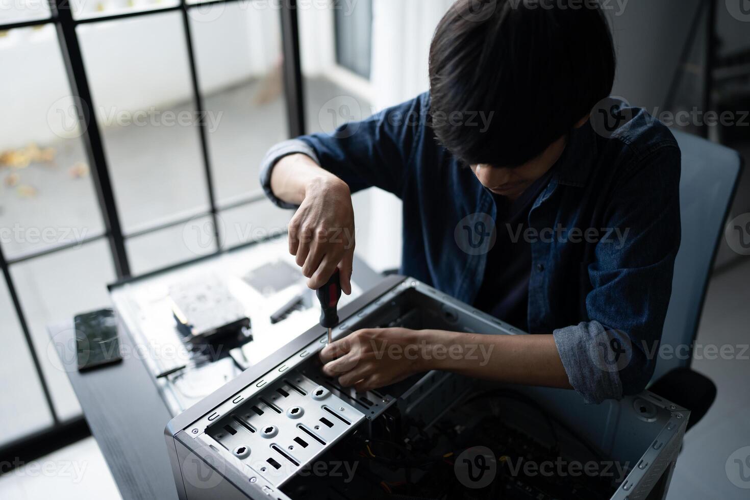 a IT Engineer man working on a computer in a room photo