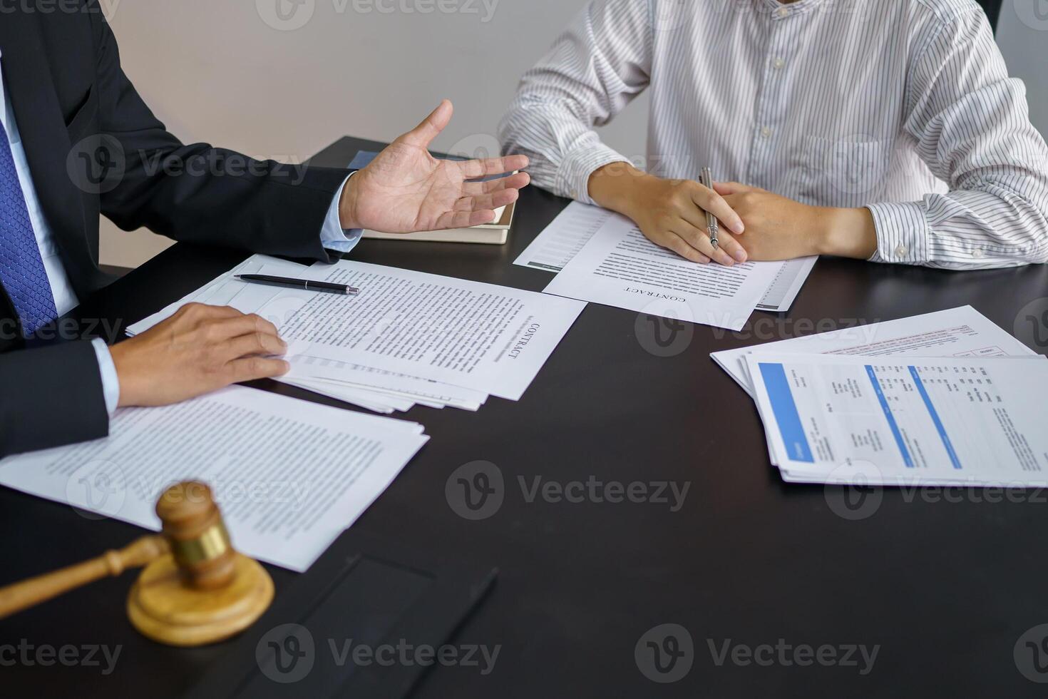 a lawyer and a client at a table photo