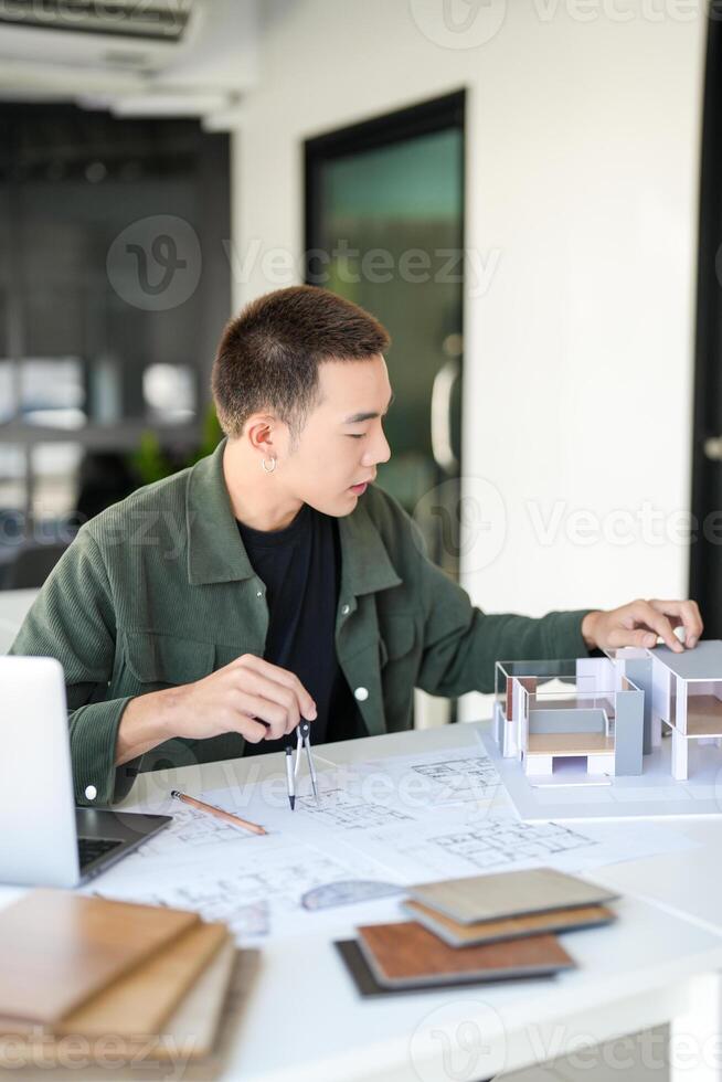 a businessman is working on a project at a desk. photo