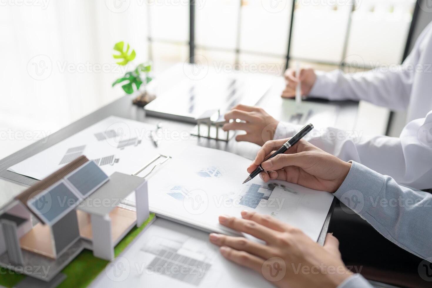 two engineers are working on a project with a house solar panel photo