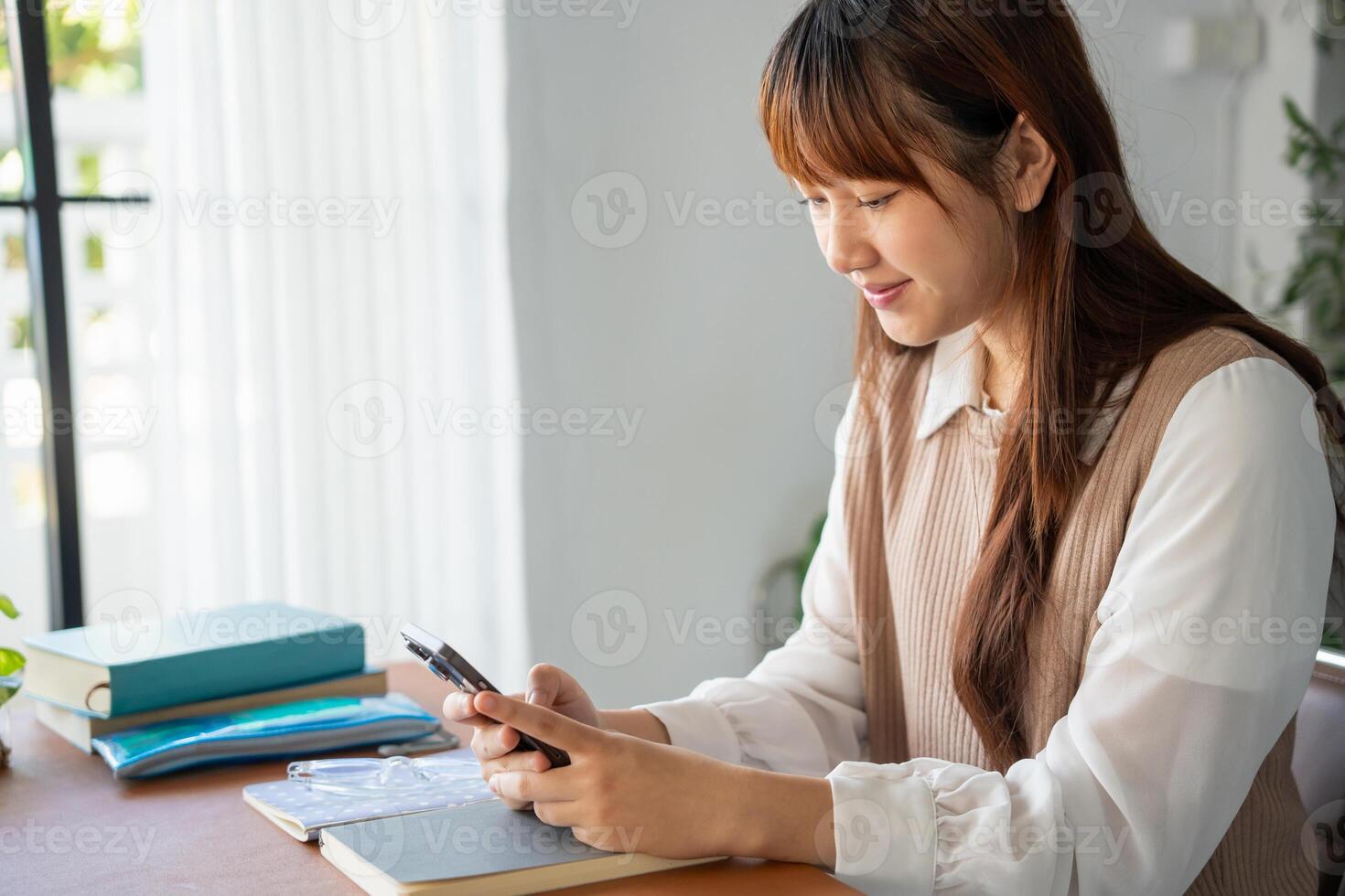 Student asian woman use smart phone in dorm room college mobile addict spending time checking news technology ecommerce. photo