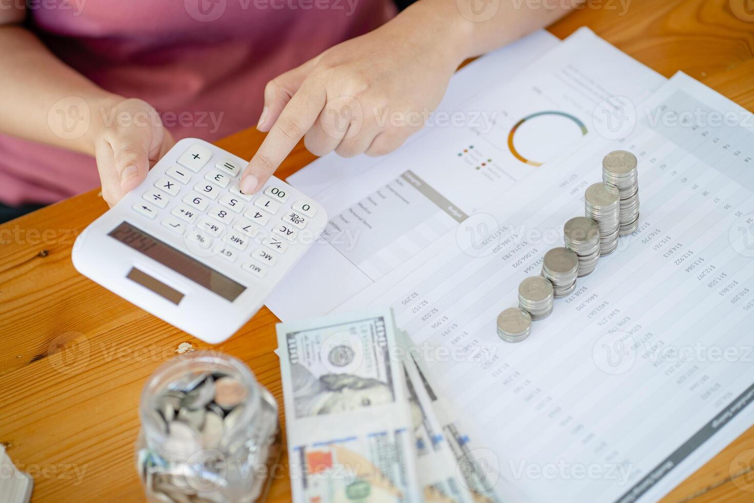 woman's hand using calculator to calculate the amount of money photo
