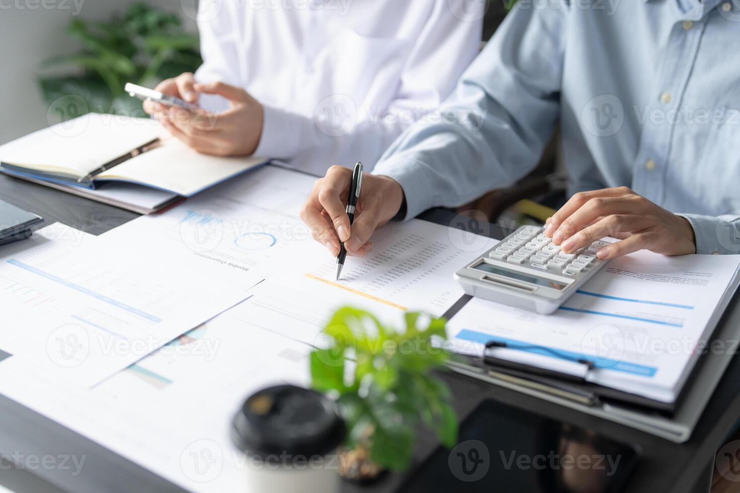 two people working on a business document in meeting room photo