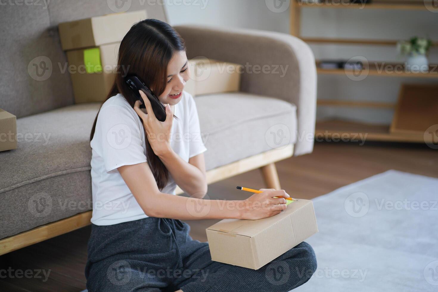 Business From Home. Asian woman preparing package delivery box Shipping for shopping online. young start up small business owner at home online order photo