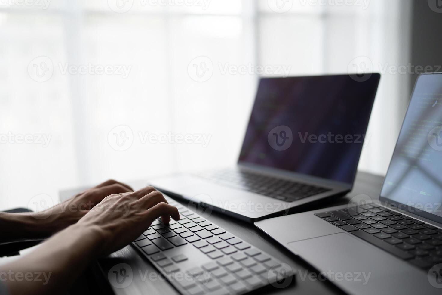Asian man software engineer Working on Computer at office desk for writing program code. IT Software Engineer finding errors tech support devops creating digital. photo