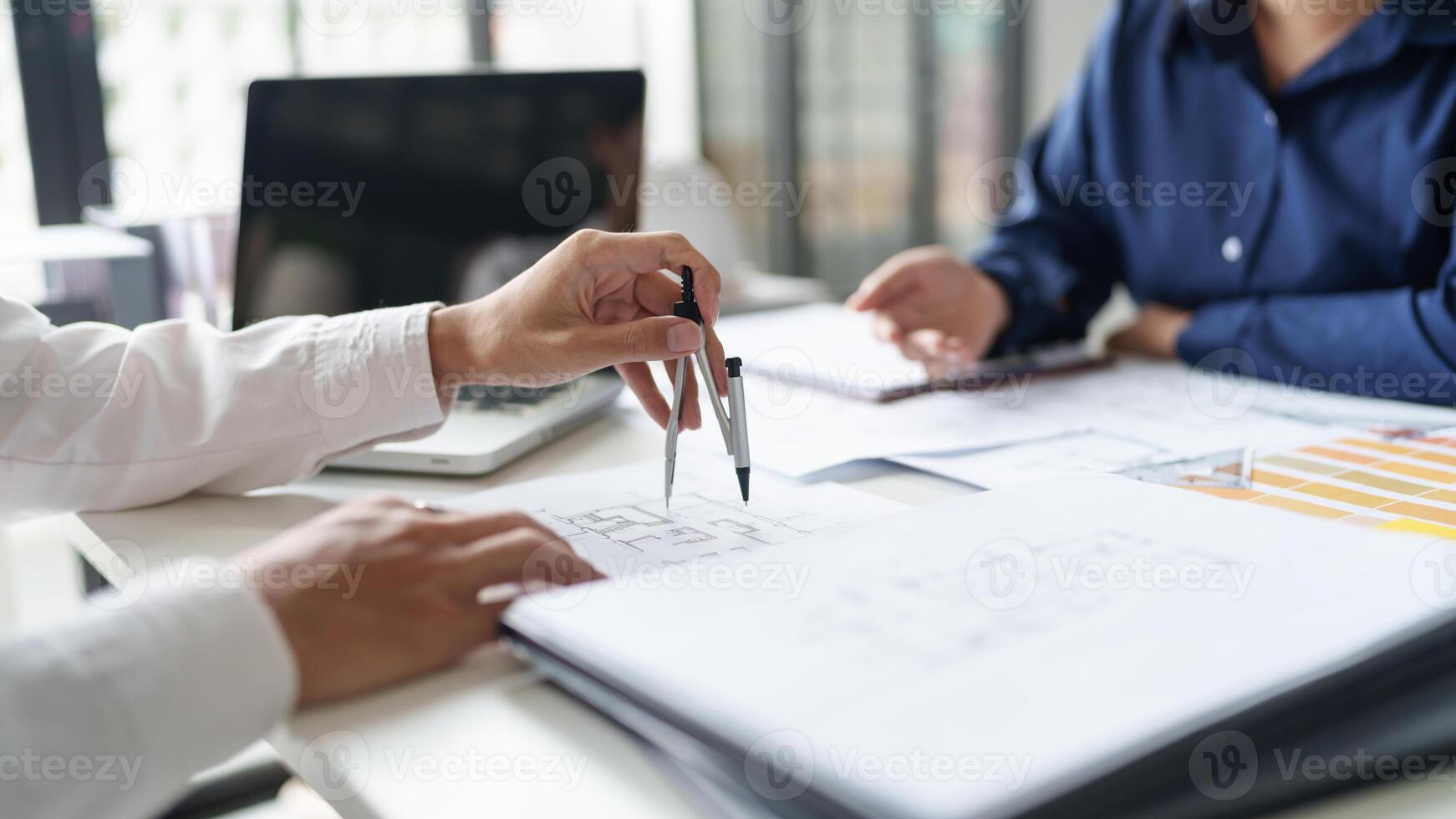 Architecture drawing on architectural working on a project at a desk photo