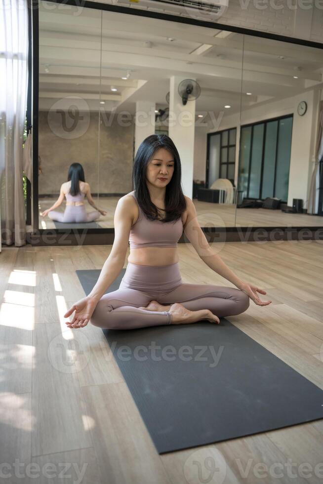 a woman in a yoga pose in a room photo
