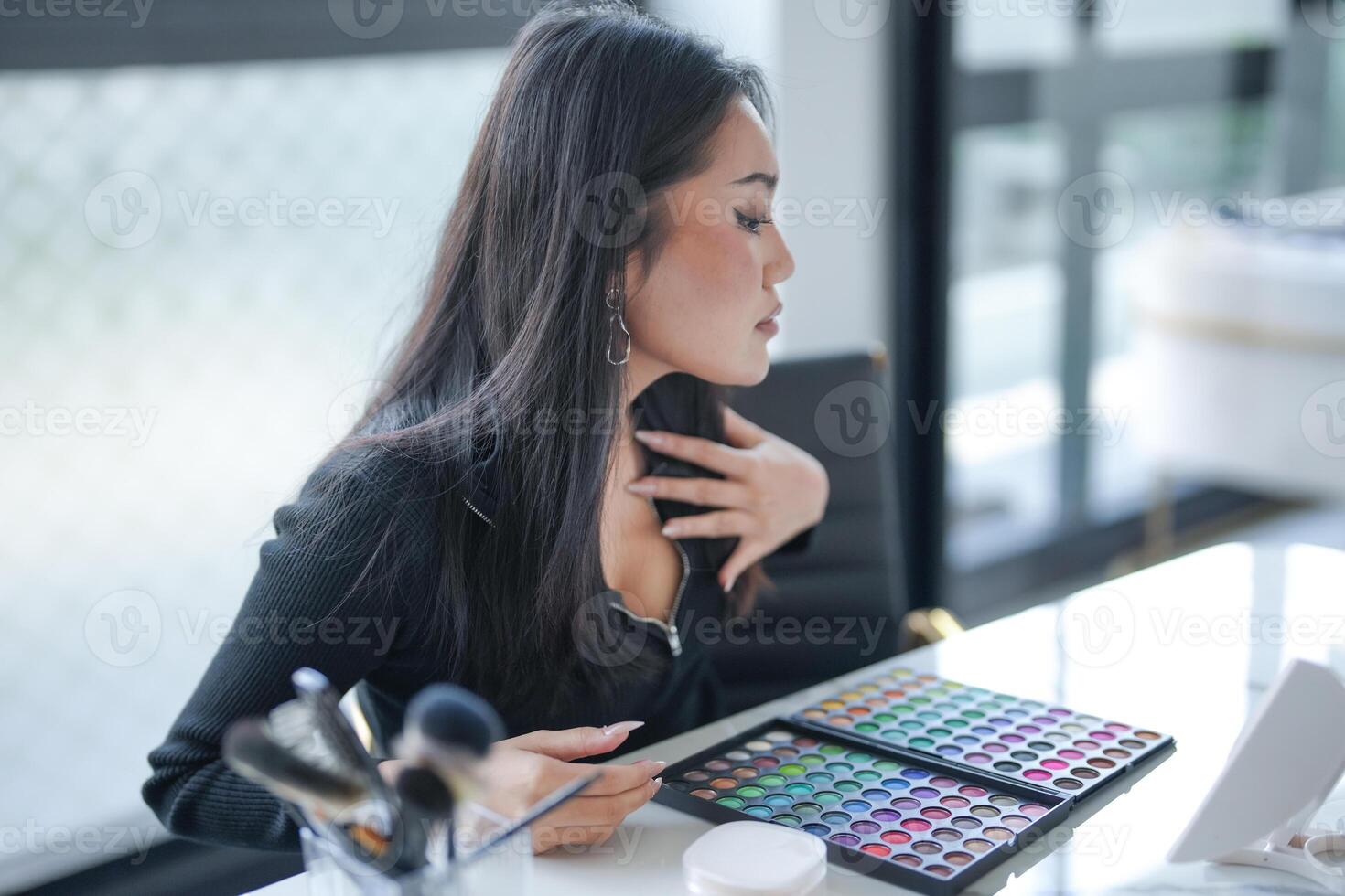 Asian girl makeup artist Professional, Woman blogger vlogger is showing cosmetics products with recording Beauty influencer asian girl online marketing photo