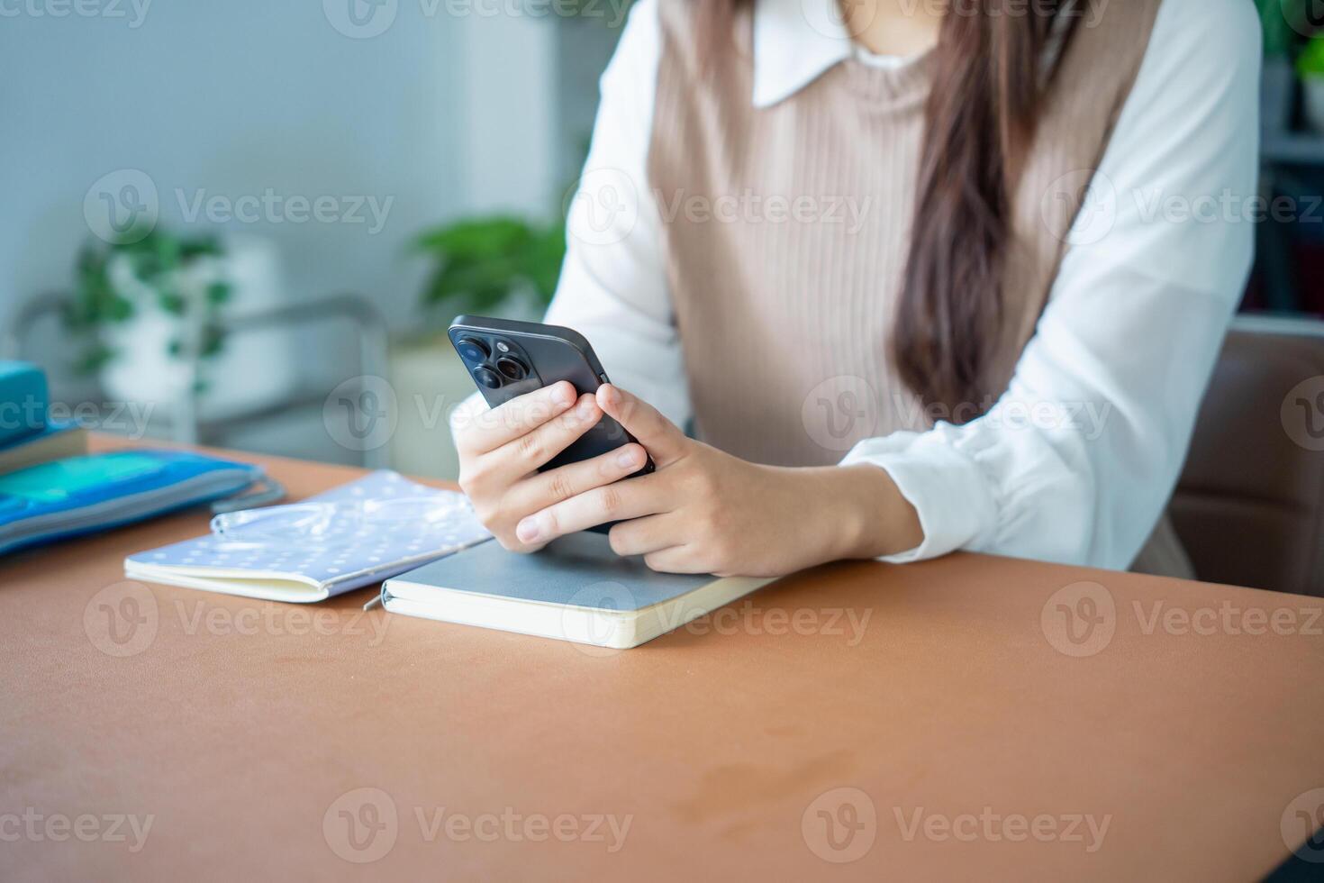 Student asian woman lying use smart phone in dorm room college mobile addict spending time checking news technology ecommerce. photo