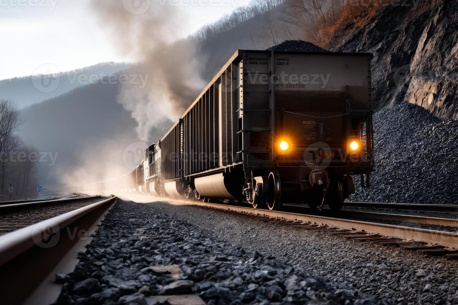 A train traveling down the tracks with smoke coming out of the engine photo
