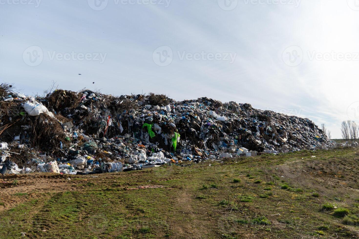 Large Landfill Pile of Trash and Waste Material Against Sky, Indicating Environmental Issues and Pollution Problems photo