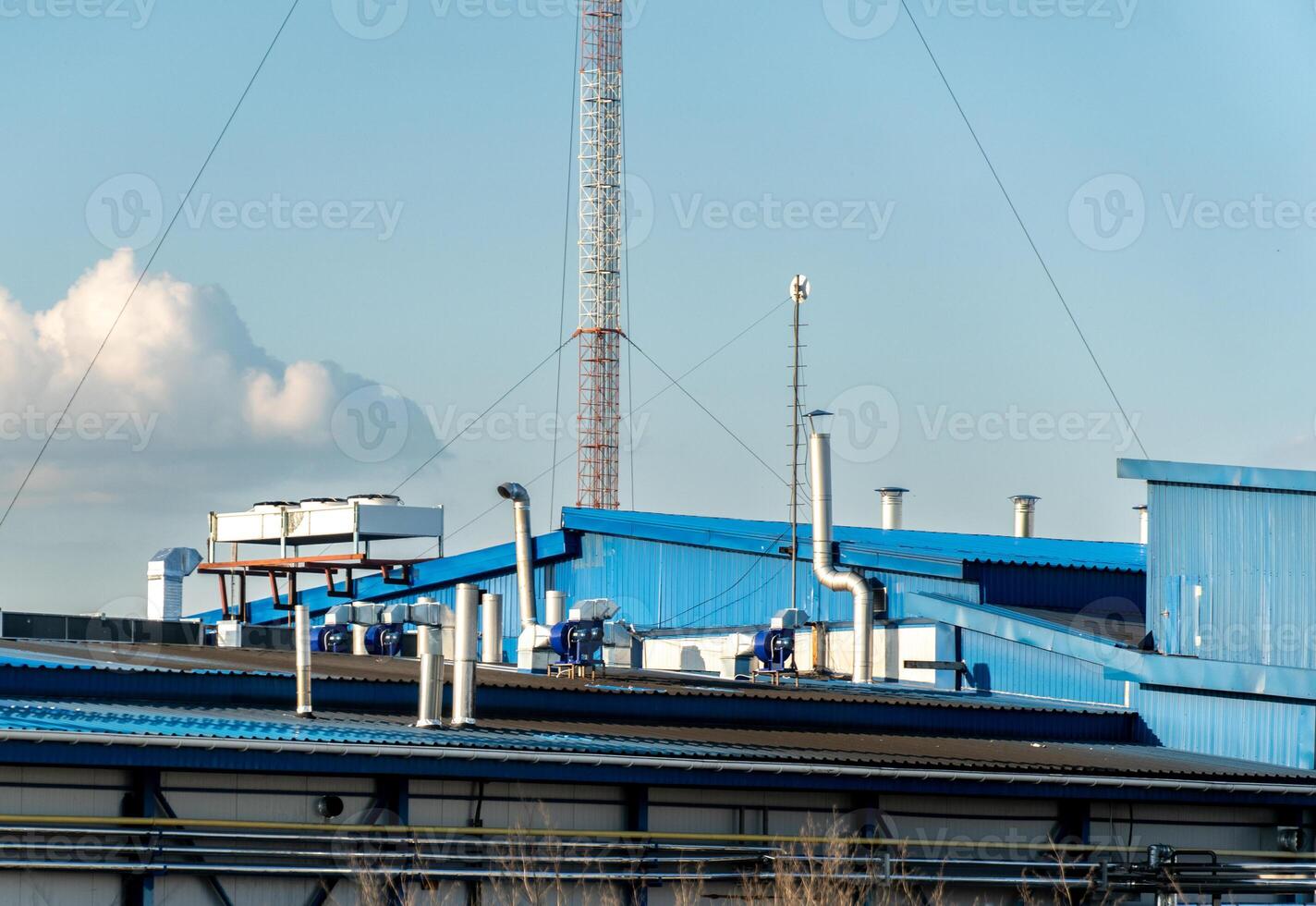 Industrial Building Rooftop with Ventilation System and a Communication Tower photo