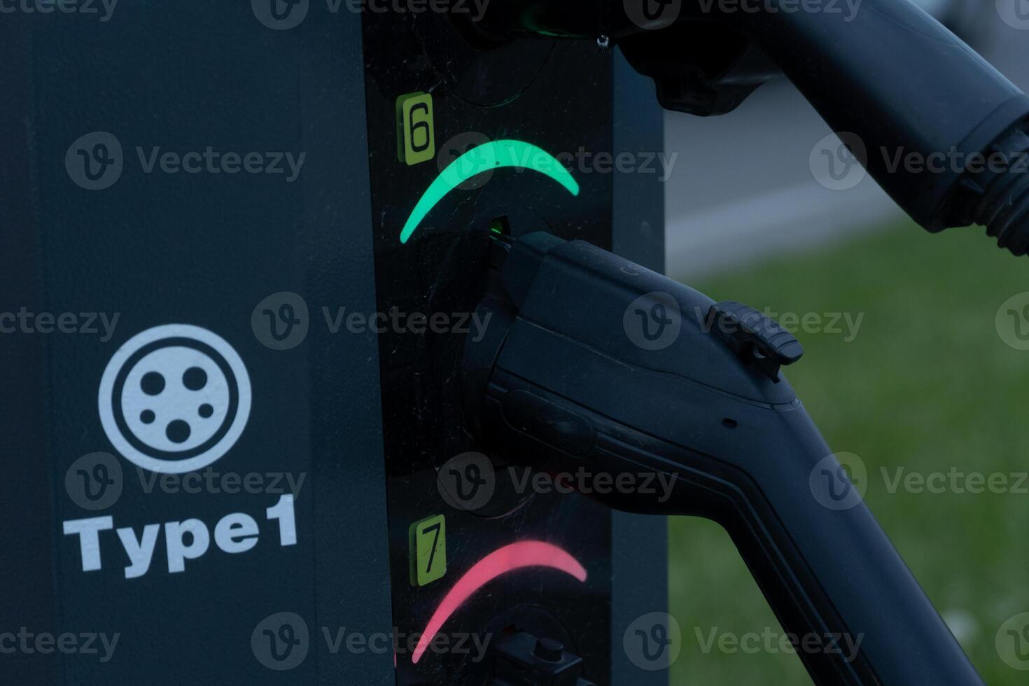 Electric vehicle charger with two connectors, one charging and one idle photo