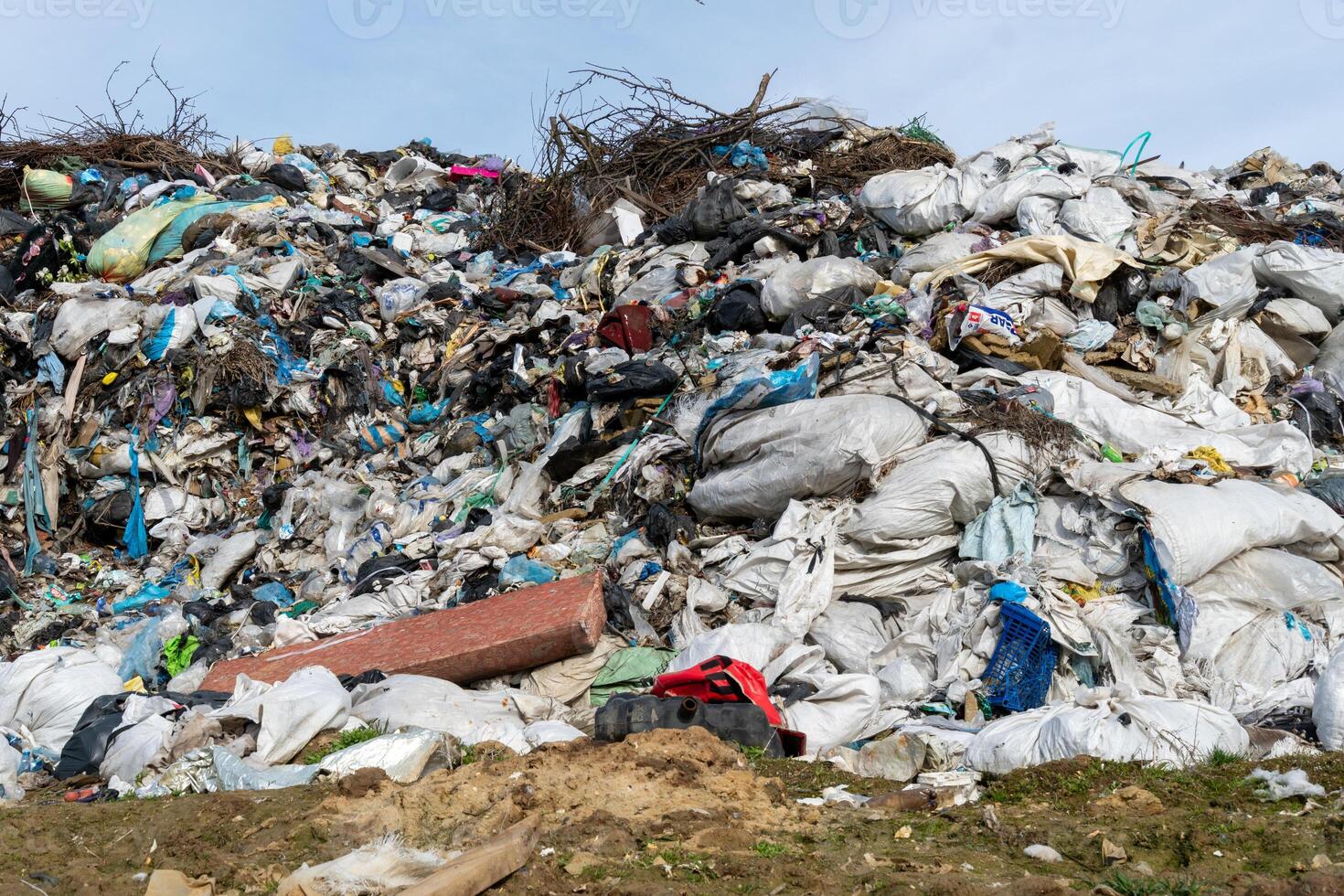 Large piles of plastic and assorted waste dominate the landfill site, cluttering the landscape while drawing attention to the pressing need for sustainable waste management photo