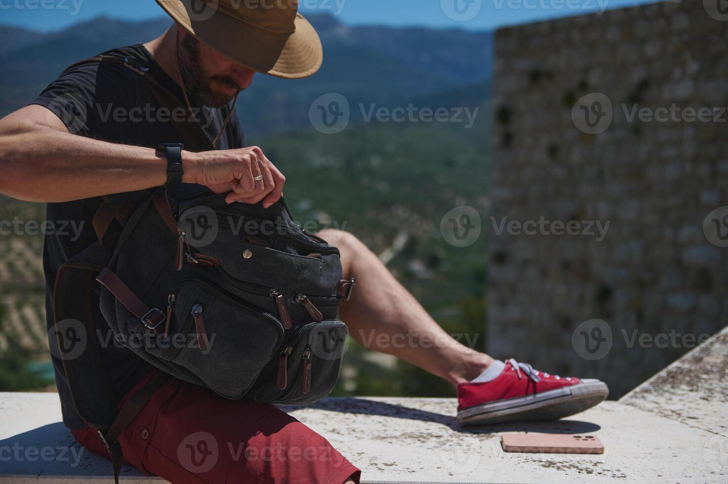 Traveler Exploring Medieval City With Backpack and Scenic Mountain View photo