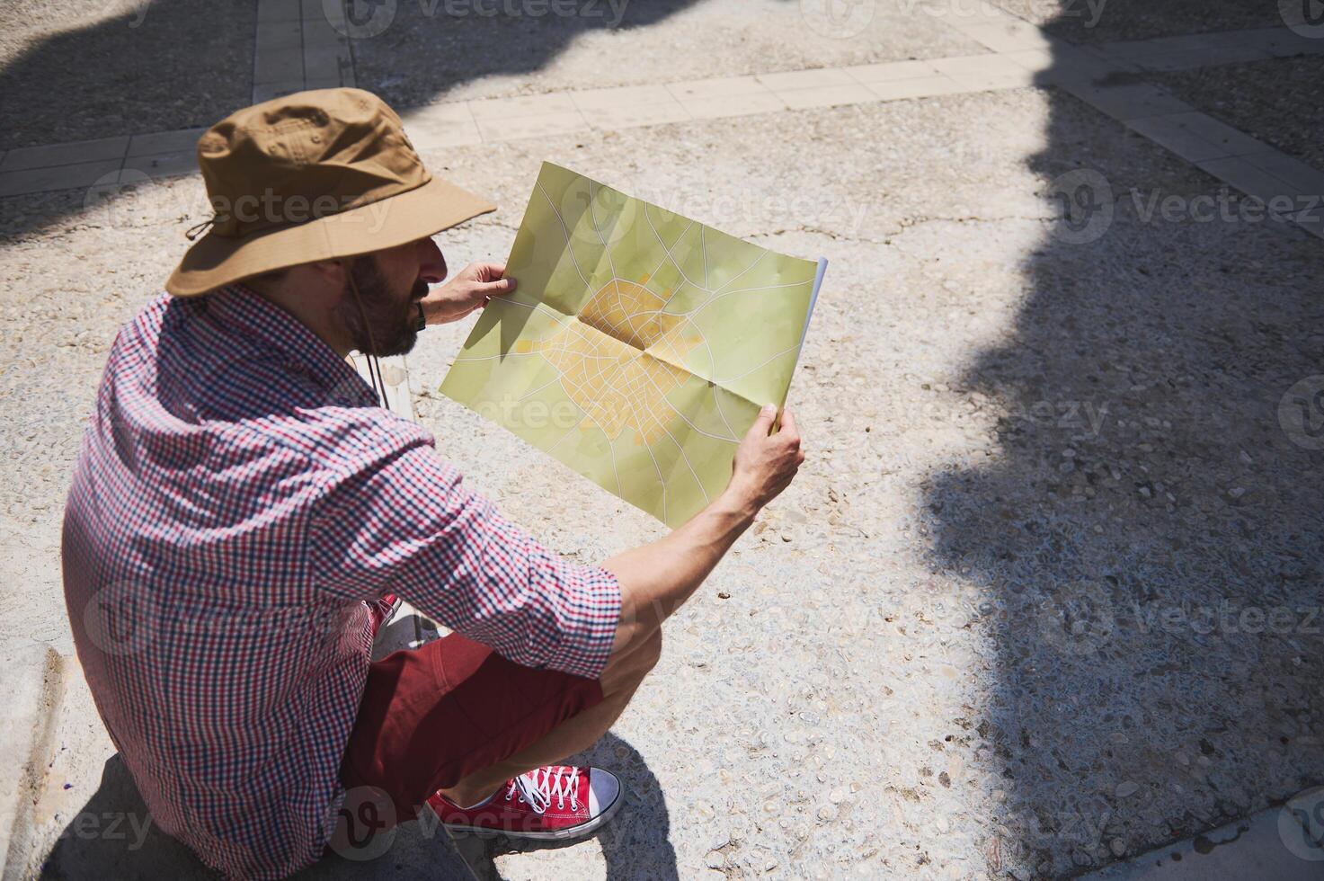 Traveler Exploring a Medieval City with a Map on a Sunny Day photo