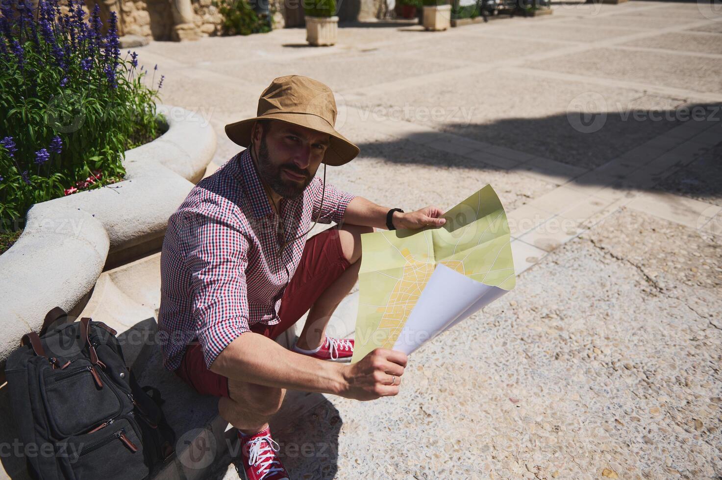 Traveler Exploring a Historic Medieval City While Reading a Map Outdoors photo