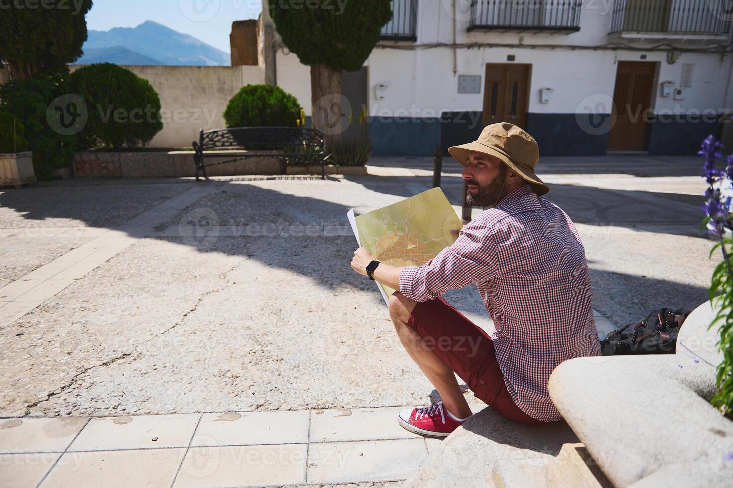 Traveler Exploring a Scenic Medieval Spanish Village with Map photo