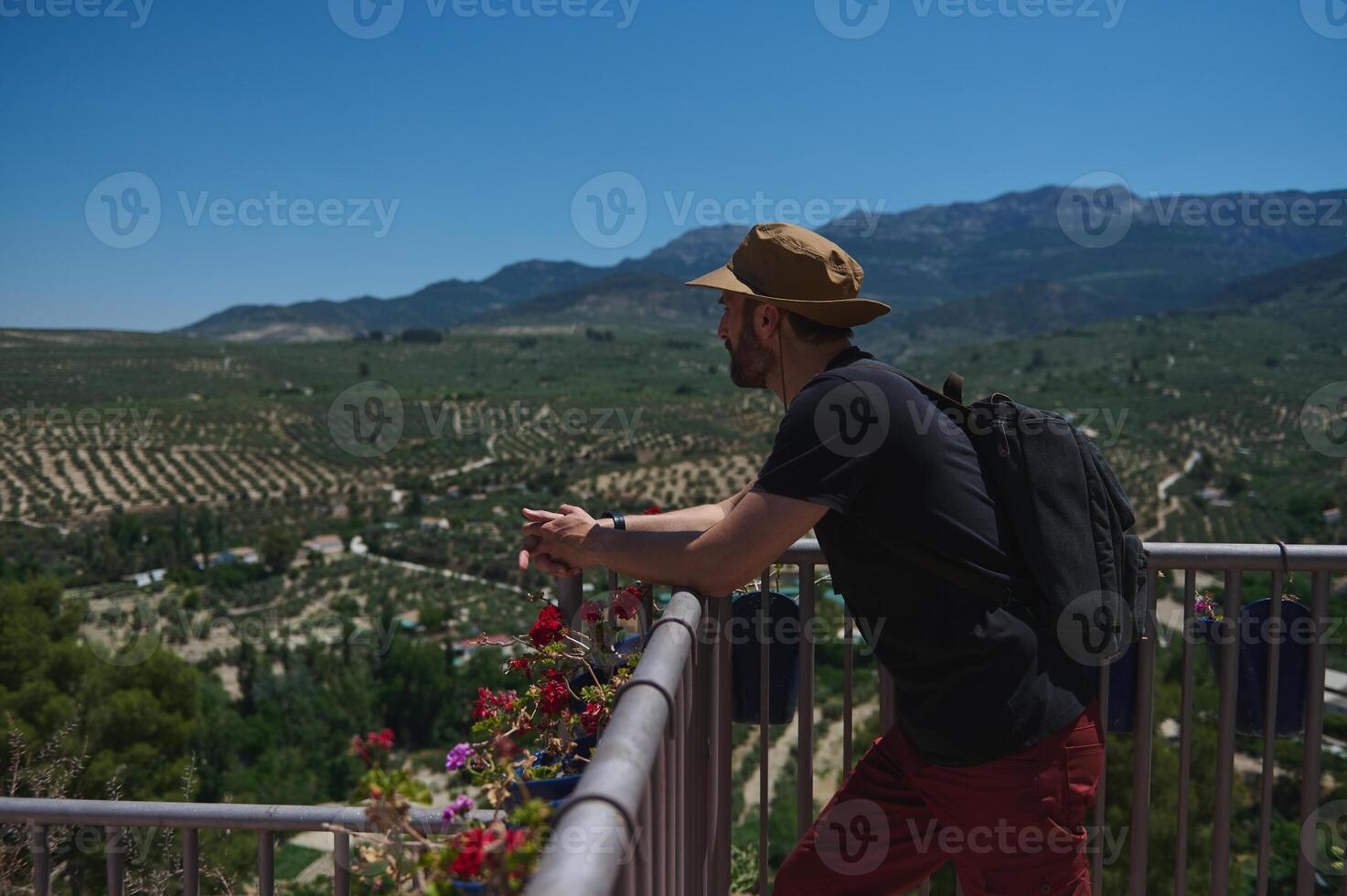 Traveler Enjoying Scenic Mountain View While Exploring Rural Landscape in Sunshine photo