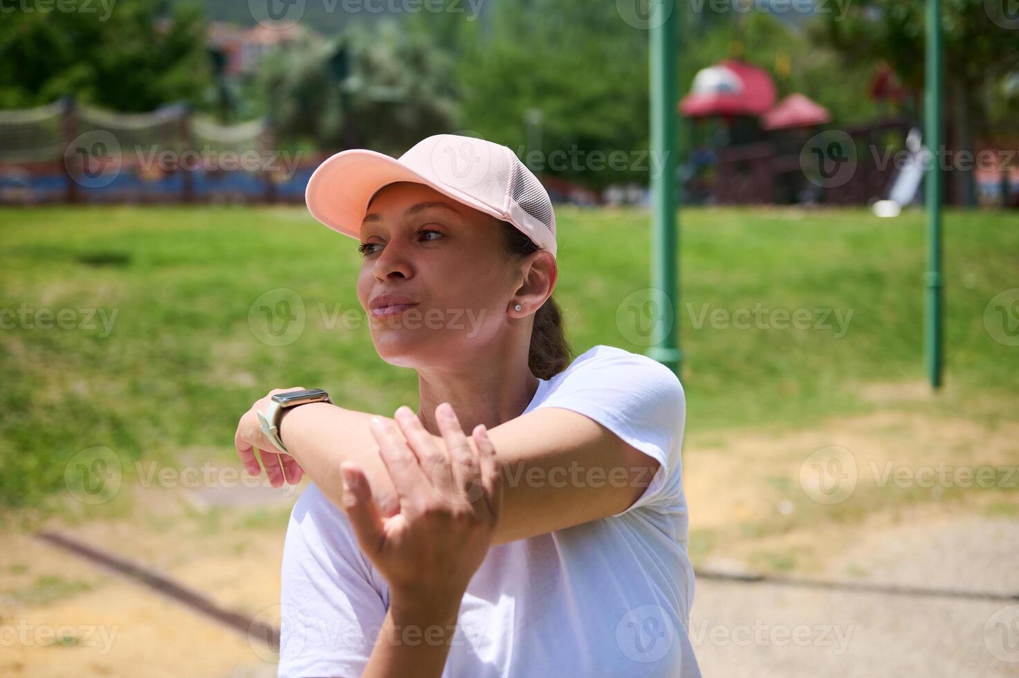 Woman Stretching Outdoors in Bright Daytime Park Setting photo