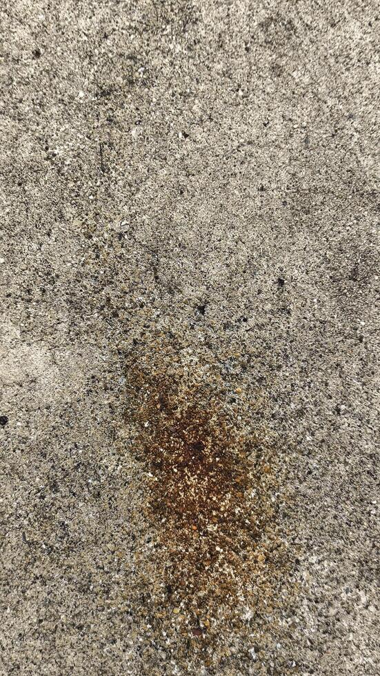 Textured Concrete Surface with Brown Stain and Aggregate photo